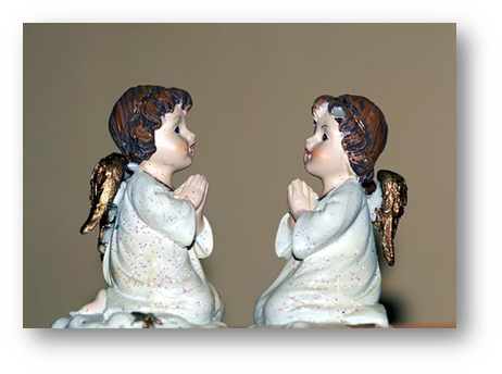 cherubs facing each other praying